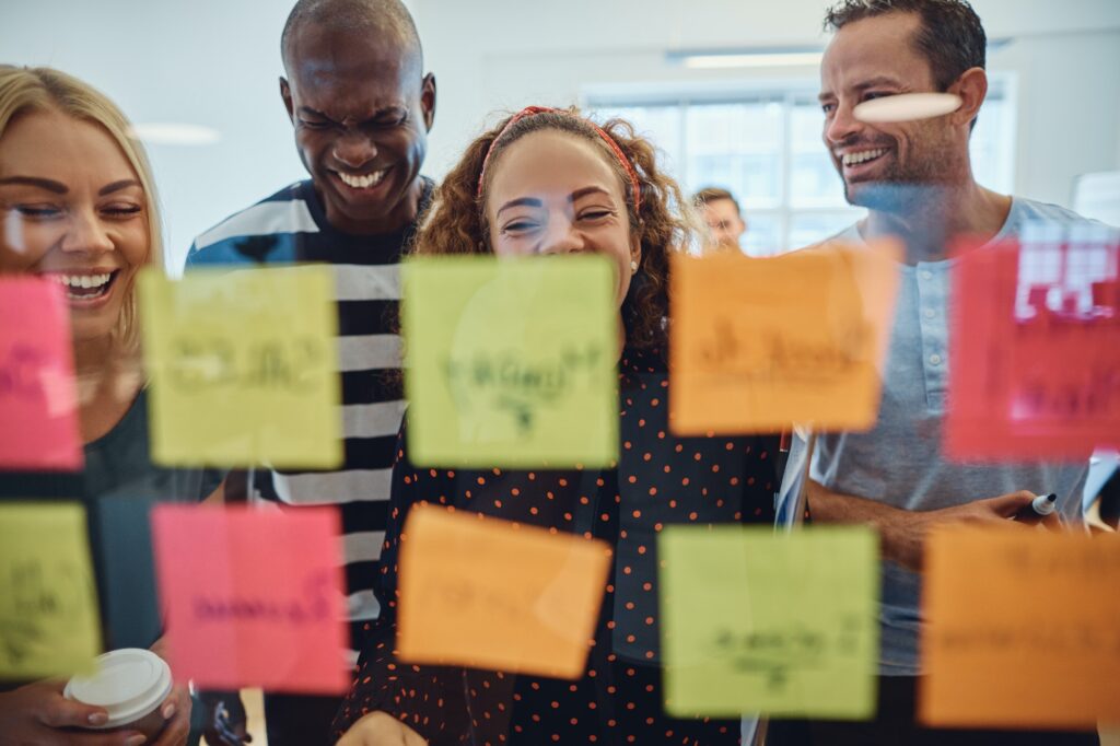 Laughing group of designers having an office brainstorming session